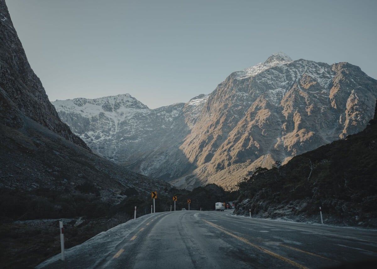 breathtaking view of milford sounds mountain range during dawn | Two Scots Abroad Breathtaking view of Milford Sound's mountain range during dawn.