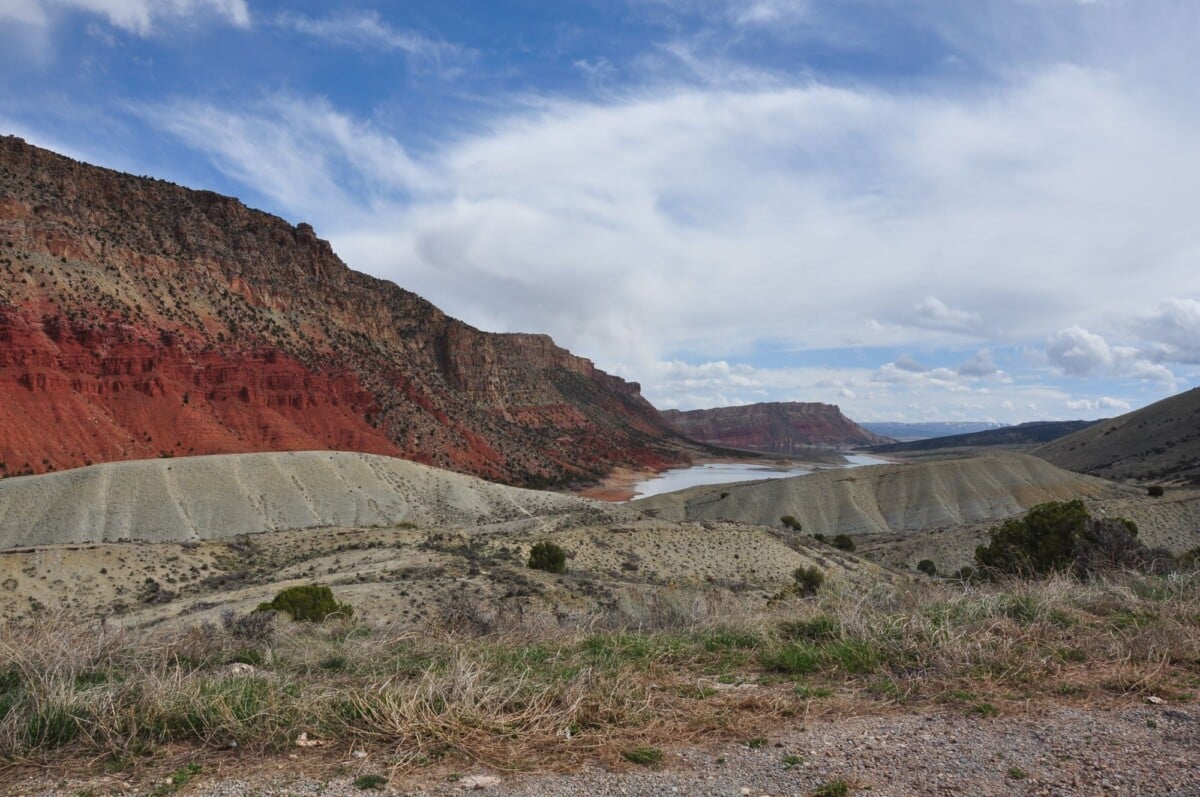breathtaking view of red canyon and lake under a vibrant blue sky in a natural s | Two Scots Abroad Breathtaking view of red canyon and lake under a vibrant blue sky in a natural setting.