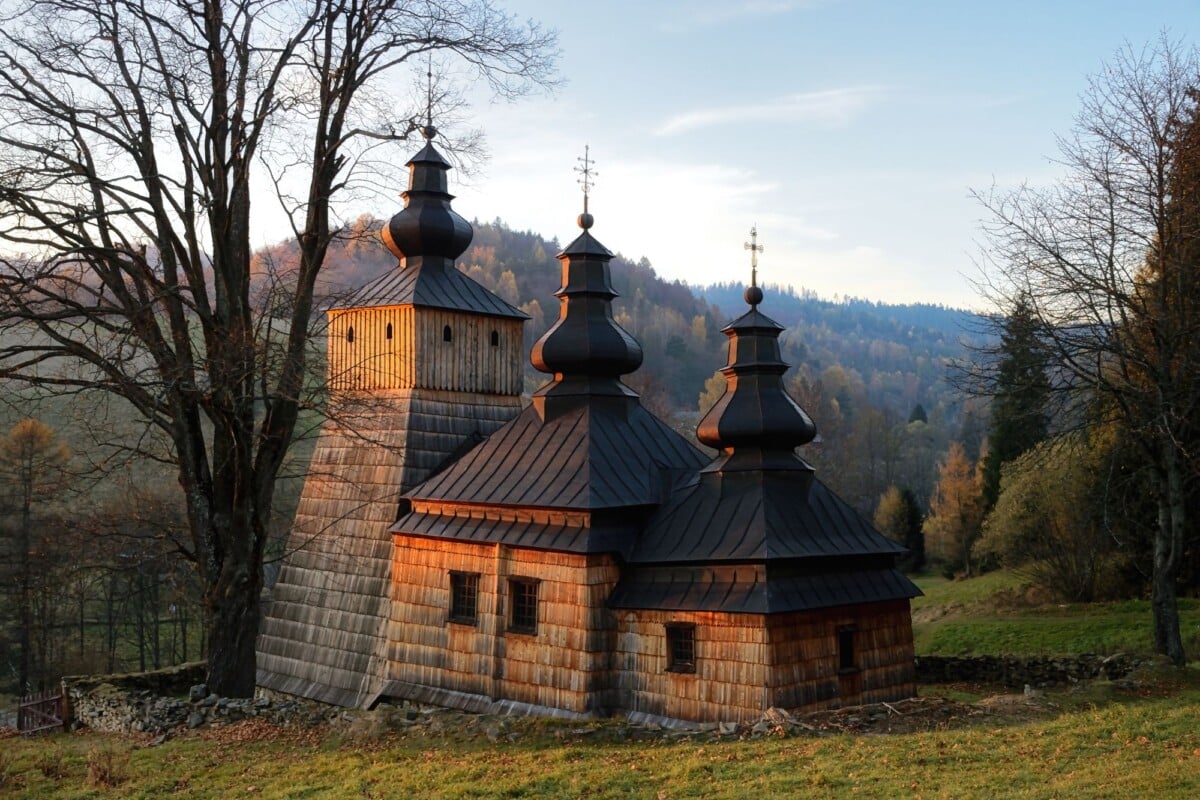 captivating view of a historic wooden church in dubne poland during a serene sun | Two Scots Abroad Captivating view of a historic wooden church in Dubne, Poland during a serene sunset.