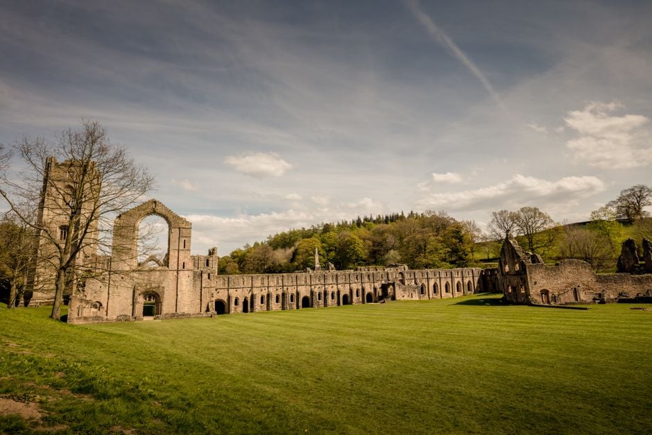 Explore the architectural beauty of the Fountains Abbey ruins in England's scenic countryside.