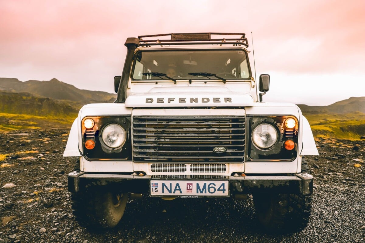 front view of a defender off road vehicle in iceland showcasing rugged landscape | Two Scots Abroad Front view of a Defender off-road vehicle in Iceland, showcasing rugged landscape.