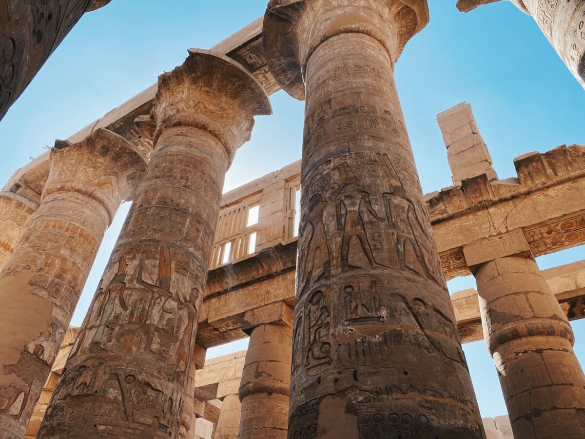 impressive ancient egyptian temple columns with hieroglyphics under a clear blue | Two Scots Abroad Impressive ancient Egyptian temple columns with hieroglyphics under a clear blue sky.