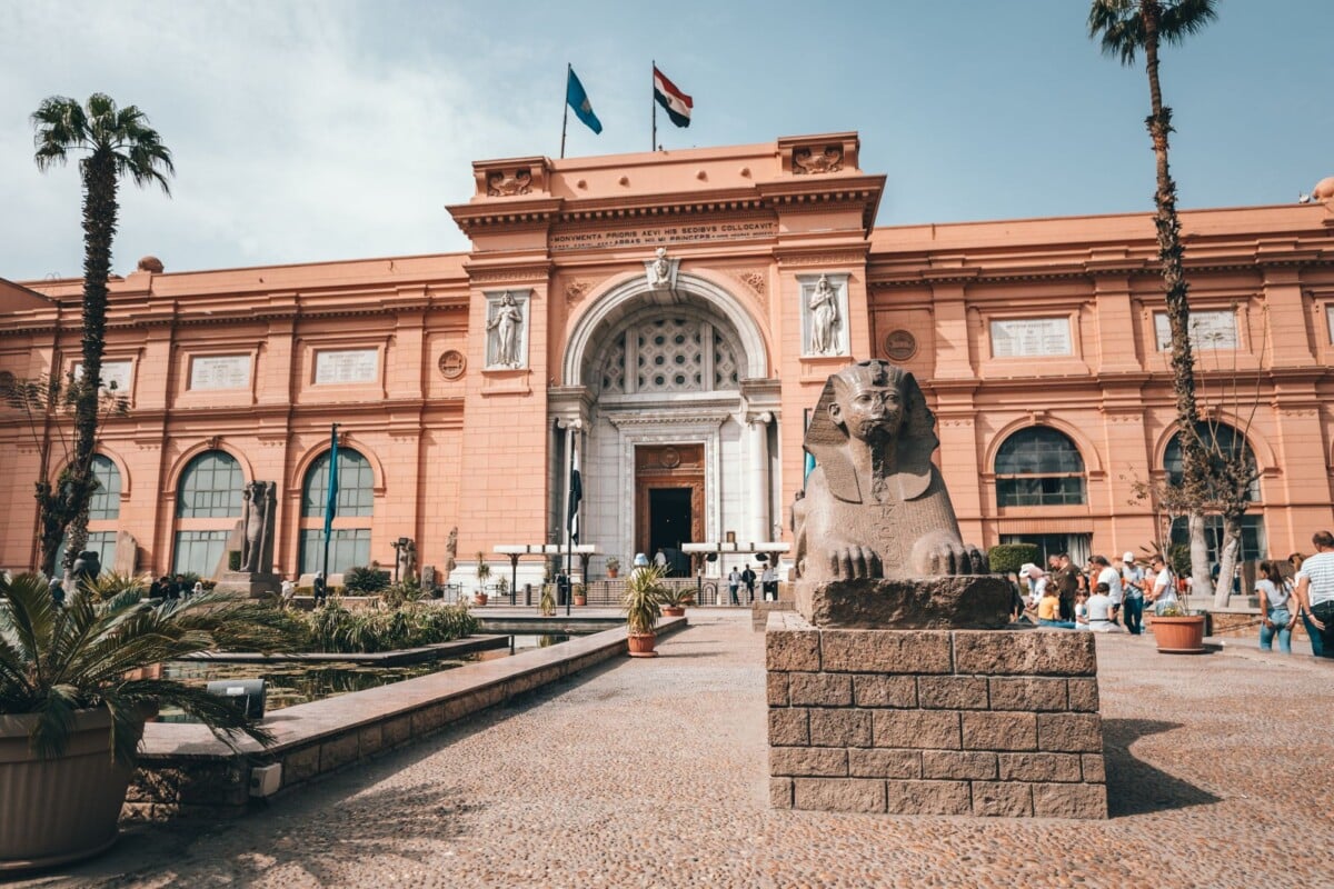low angle of aged building of egyptian museum located in cairo with arched doorw | Two Scots Abroad Low angle of aged building of Egyptian Museum located in Cairo with arched doorway and ancient statues in yard