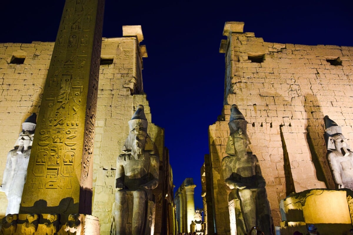 night view of the illuminated luxor temple with ancient statues and hieroglyphs | Two Scots Abroad Night view of the illuminated Luxor Temple with ancient statues and hieroglyphs.