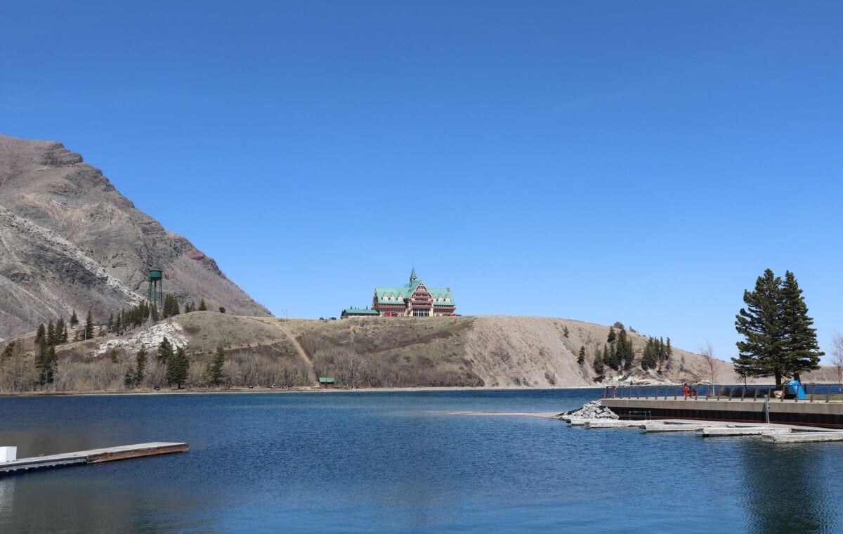 picturesque landscape of prince of wales hotel overlooking waterton lake with cl | Two Scots Abroad Picturesque landscape of Prince of Wales Hotel overlooking Waterton Lake with clear blue skies.