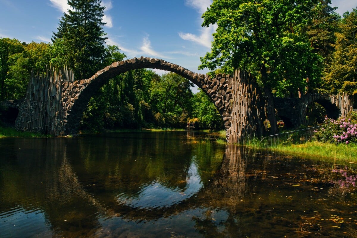 scenic view of rakotzbrucke arch reflected in the clear waters of rakotz lake ge | Two Scots Abroad Scenic view of Rakotzbrücke arch reflected in the clear waters of Rakotz Lake, Germany.