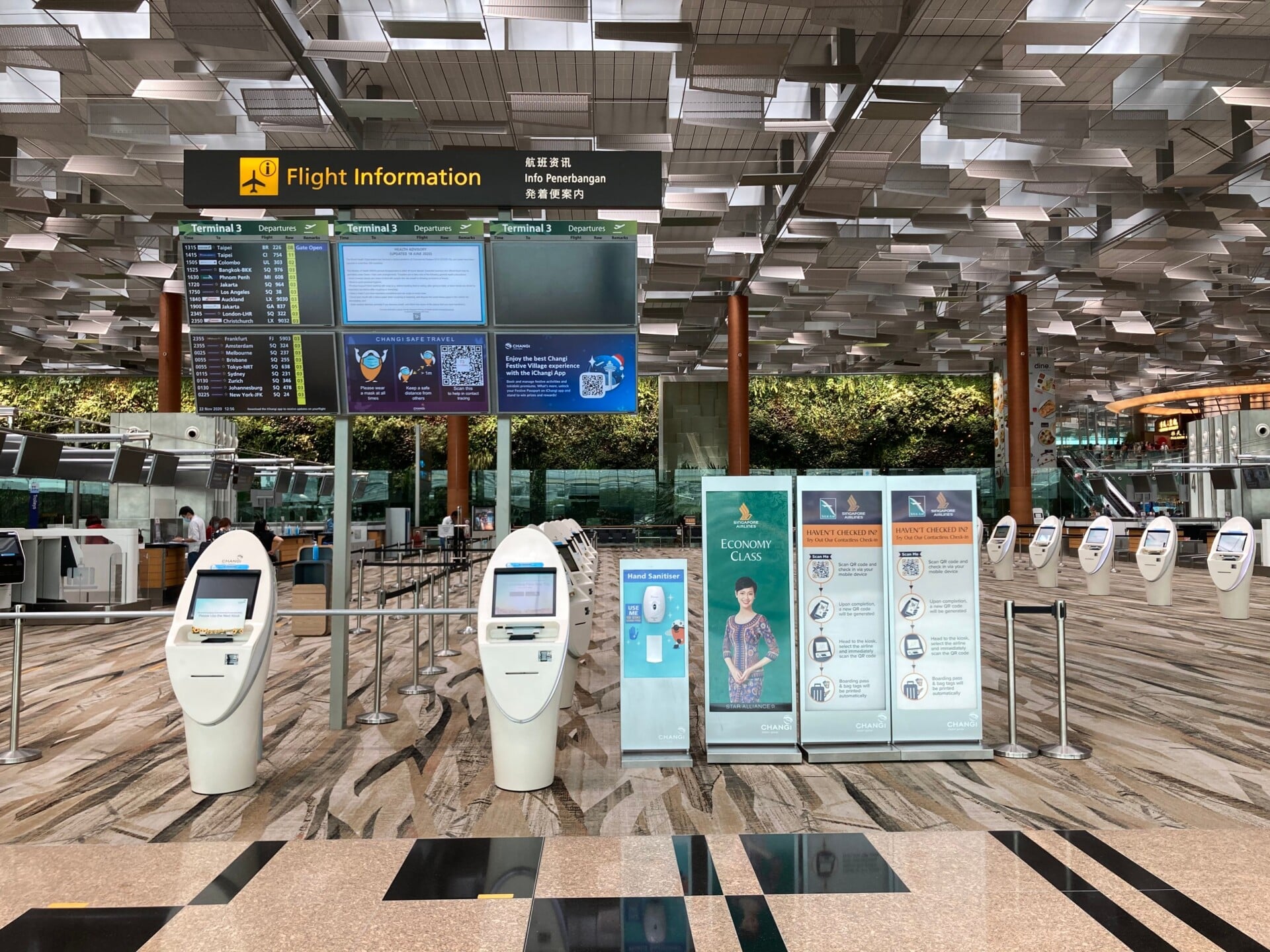 spacious airport lobby featuring flight information displays and self check in k | Two Scots Abroad Spacious airport lobby featuring flight information displays and self-check-in kiosks.