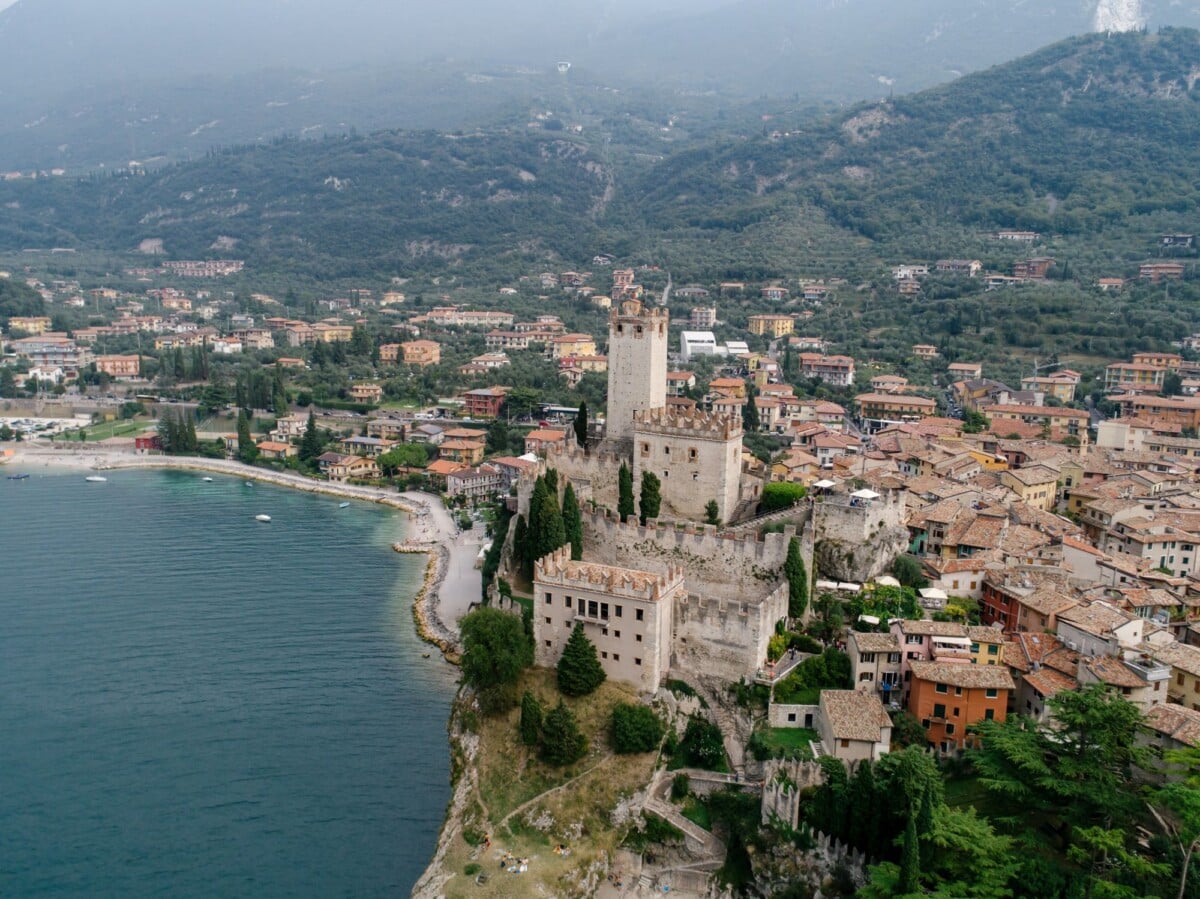 Stunning aerial view of Malcesine Castle, a medieval fortress by Lake Garda, Italy.