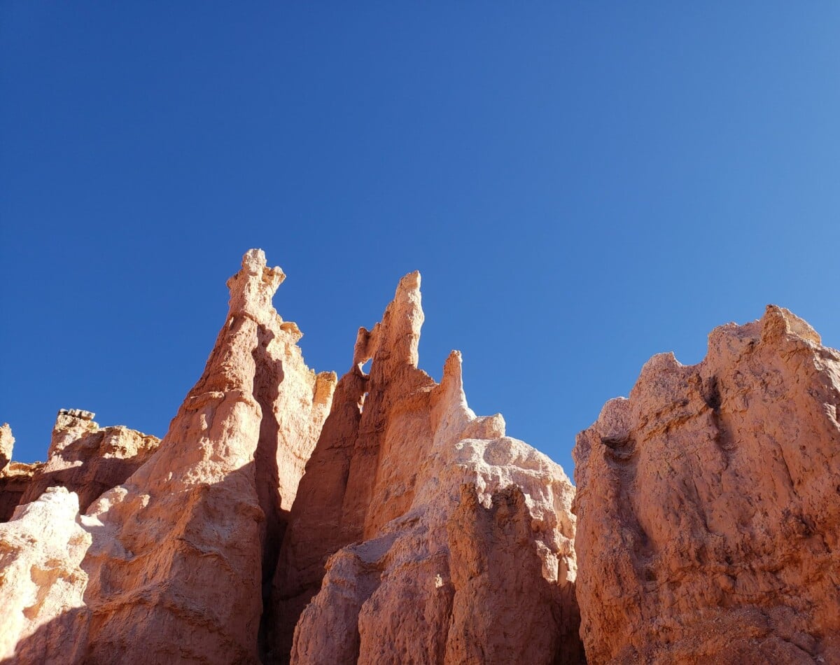 stunning sandstone formations reach up under a clear blue sky showcasing natural | Two Scots Abroad Stunning sandstone formations reach up under a clear blue sky, showcasing natural beauty.