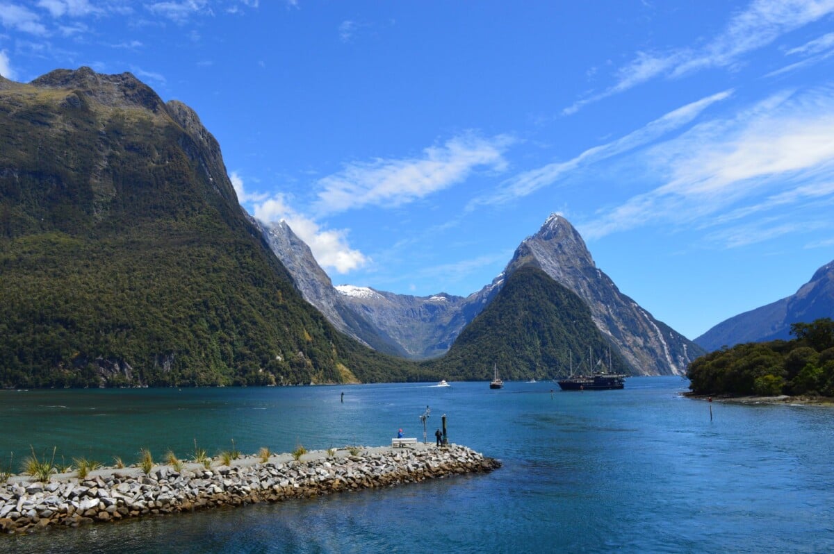 stunning view of milford sounds scenic fjord with mountains and calm waters in n | Two Scots Abroad Stunning view of Milford Sound's scenic fjord with mountains and calm waters in New Zealand.