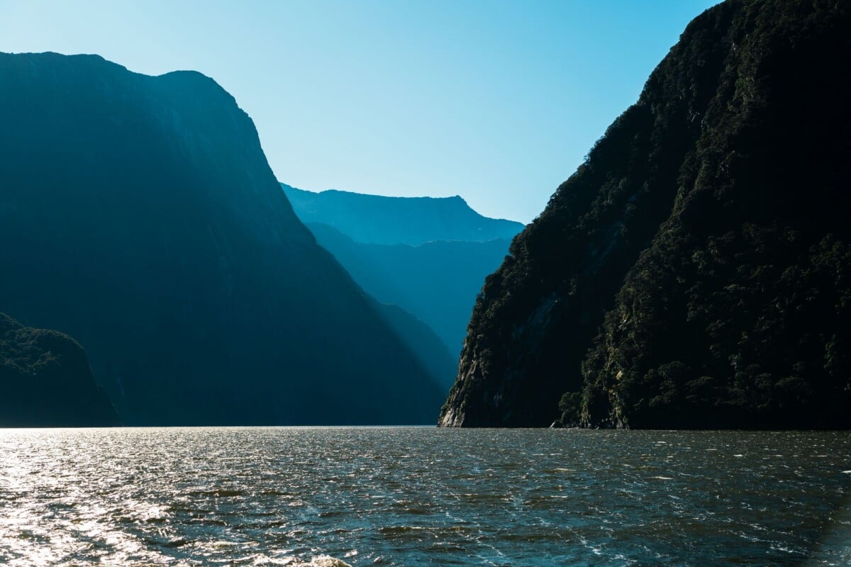 tranquil view of milford sounds fjords and mountains under clear skies new zeala | Two Scots Abroad Tranquil view of Milford Sound's fjords and mountains under clear skies, New Zealand.