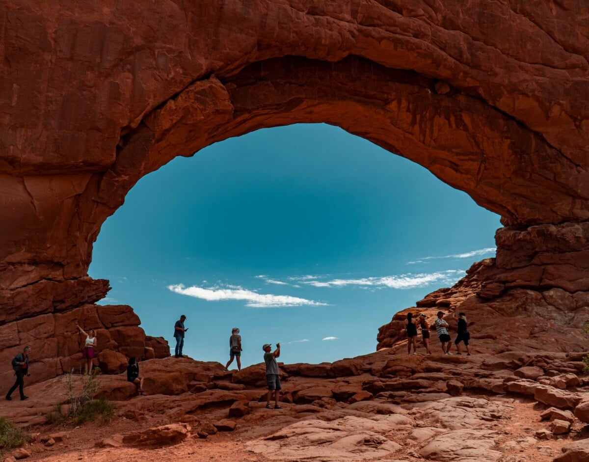 visitors admire the stunning natural arch formation at arches national park utah | Two Scots Abroad Visitors admire the stunning natural arch formation at Arches National Park, Utah.