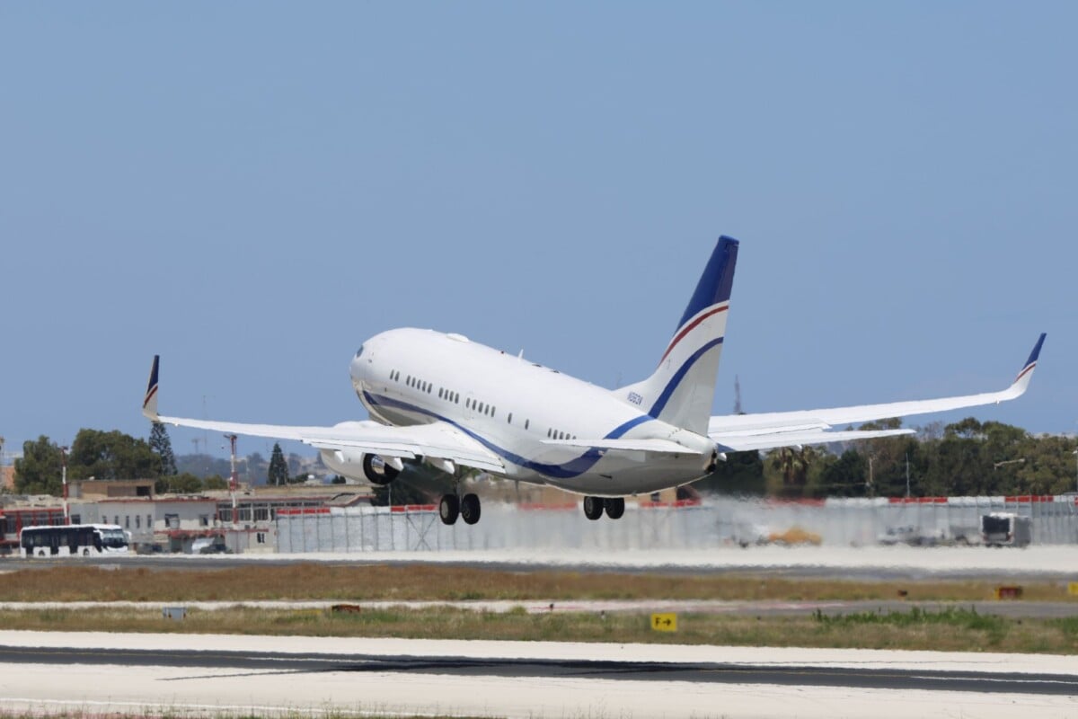 a commercial airplane takes off from a runway on a clear day showcasing aviation | Two Scots Abroad A commercial airplane takes off from a runway on a clear day, showcasing aviation and travel concepts.