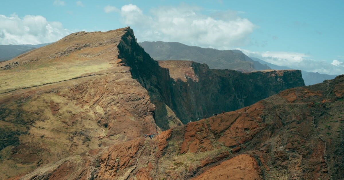 a scenic view of the rugged cliffs in madeira portugal under a bright summer sky | Two Scots Abroad A scenic view of the rugged cliffs in Madeira, Portugal under a bright summer sky.
