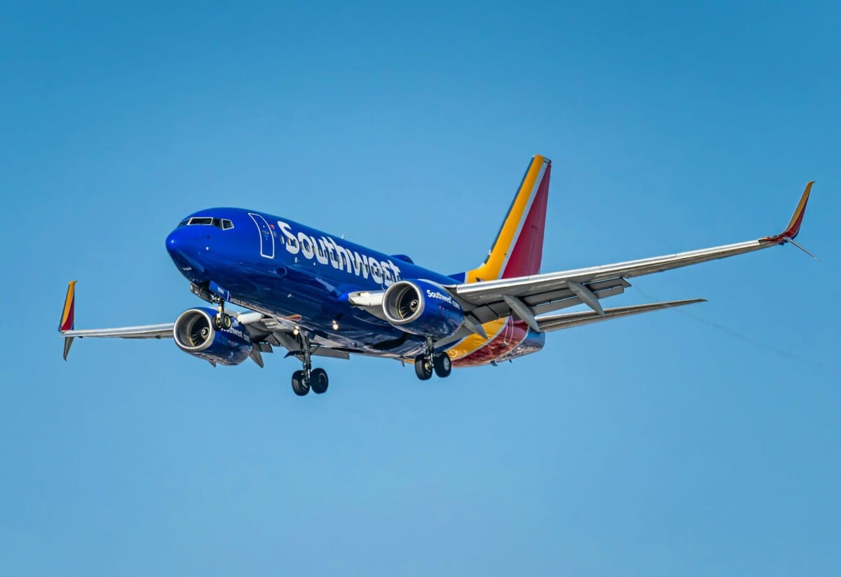 a southwest airlines boeing 737 aircraft flying over los angeles clear blue sky | Two Scots Abroad A Southwest Airlines Boeing 737 aircraft flying over Los Angeles, clear blue sky.