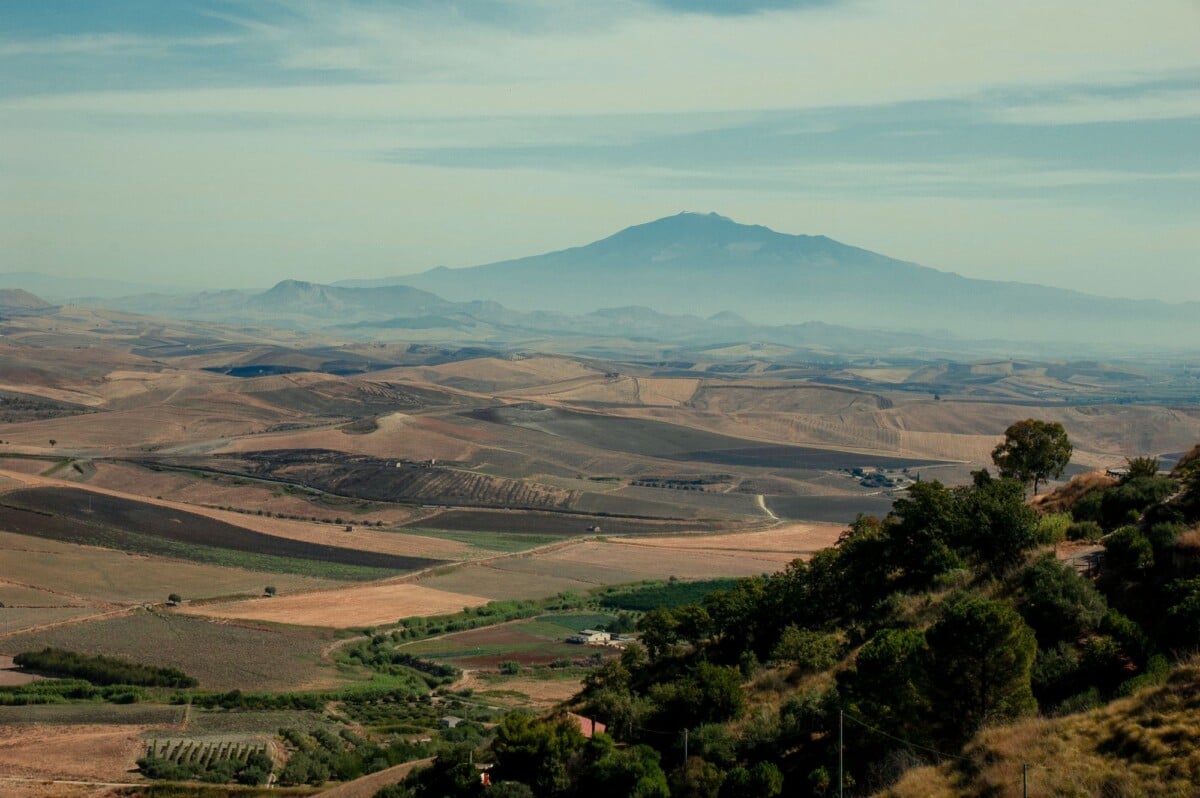 aerial landscape with rolling hills and mount etna in the distance captured in c | Two Scots Abroad Aerial landscape with rolling hills and Mount Etna in the distance, captured in Catania, Sicily.