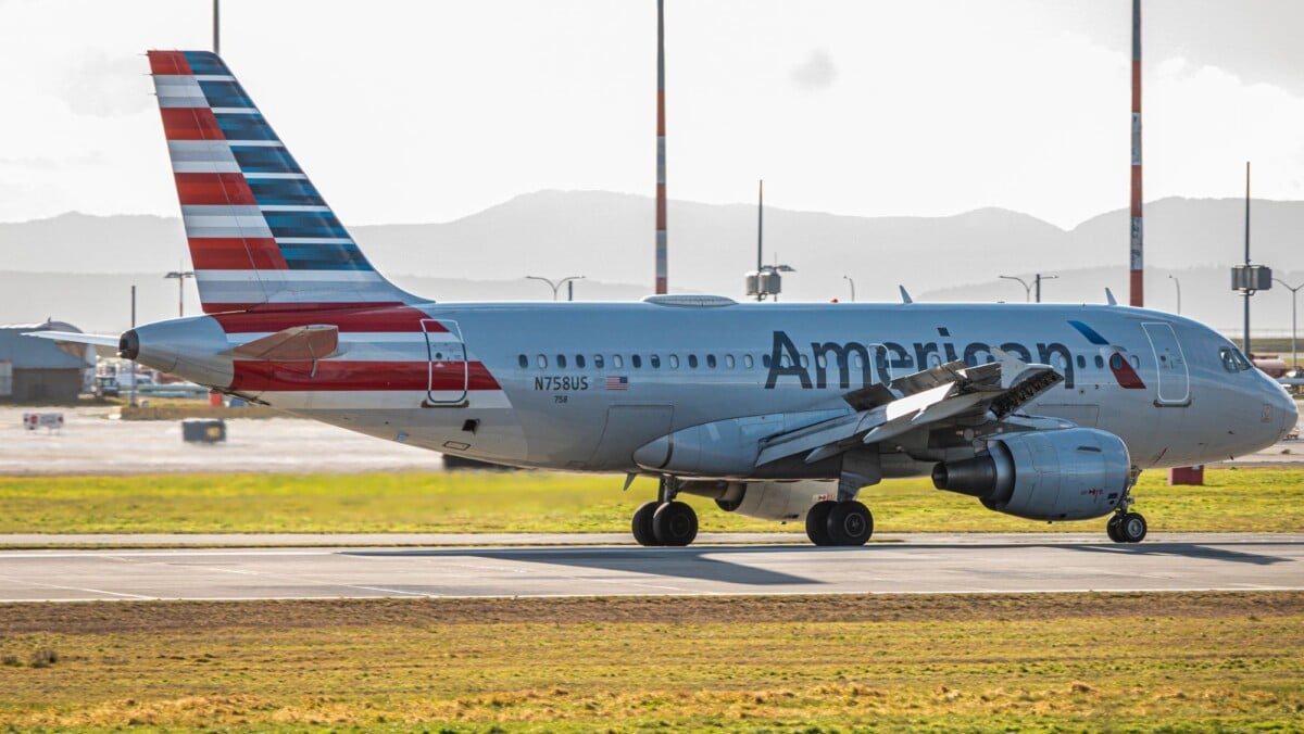 american airlines airplane on the tarmac during daylight featuring bright colors | Two Scots Abroad American Airlines airplane on the tarmac during daylight, featuring bright colors and clear aviation details.