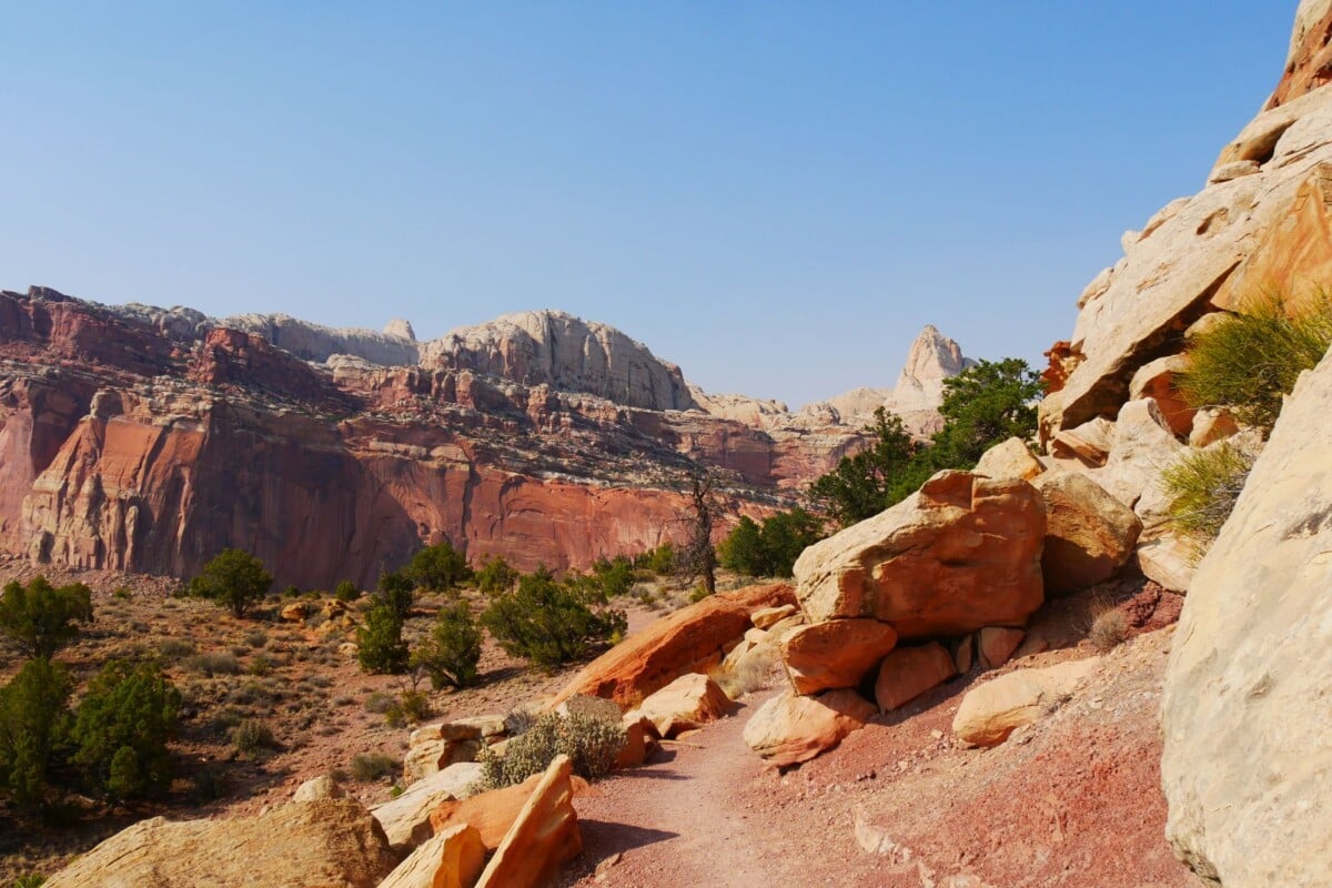 beautiful view of red rock formations in capitol reef national park under a clea | Two Scots Abroad Beautiful view of red rock formations in Capitol Reef National Park under a clear blue sky.
