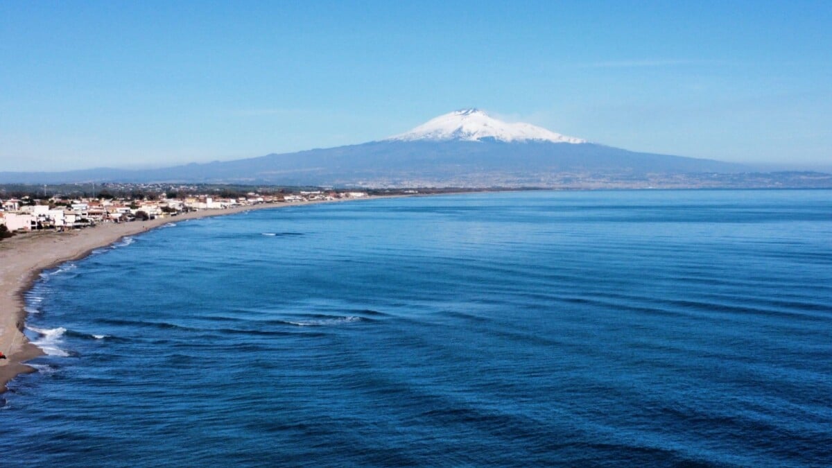 breathtaking aerial view of mount etna with the tranquil sicilian coastline in t | Two Scots Abroad Breathtaking aerial view of Mount Etna with the tranquil Sicilian coastline in the foreground.