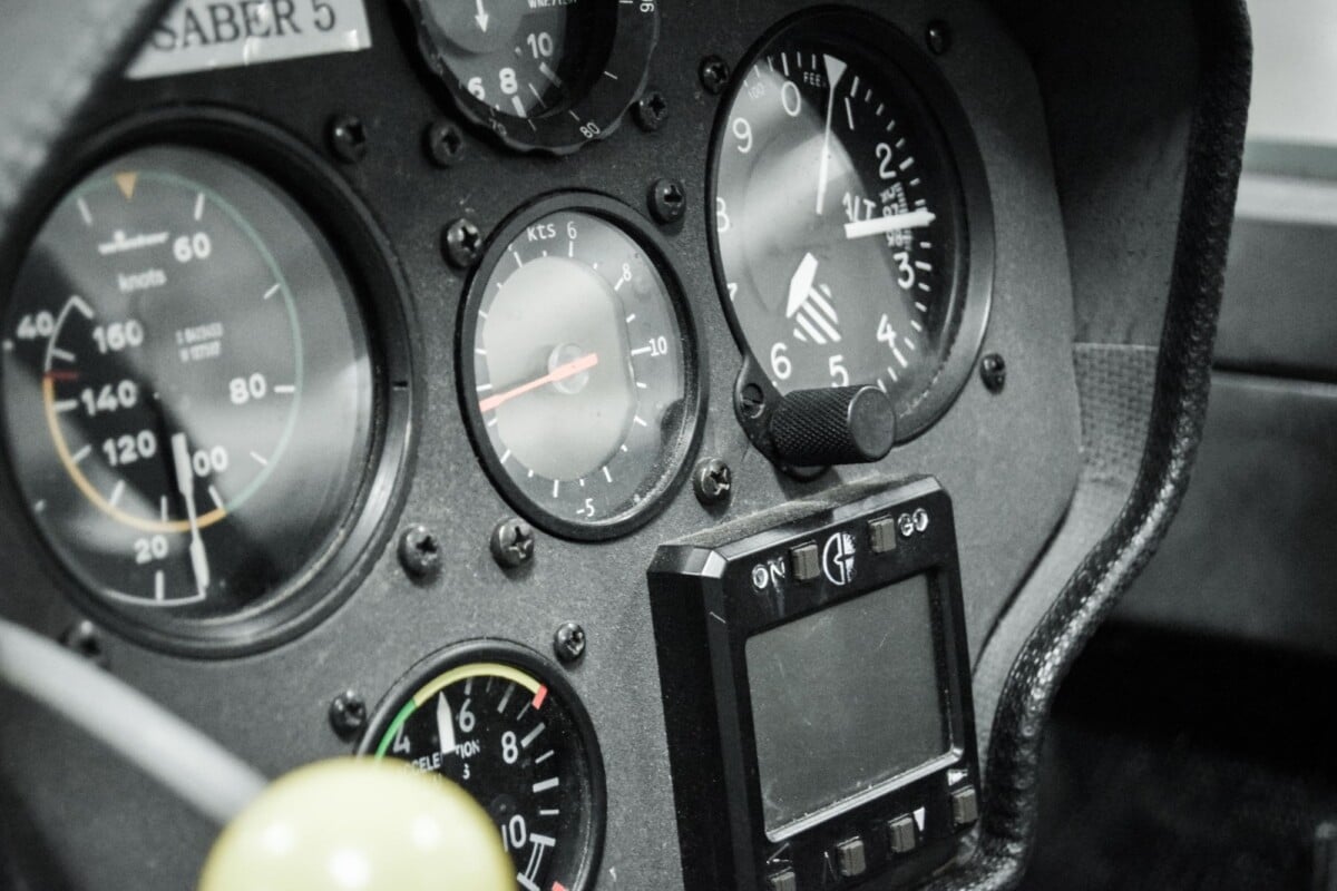 Close-up of various aircraft cockpit dashboard meters and gauges.