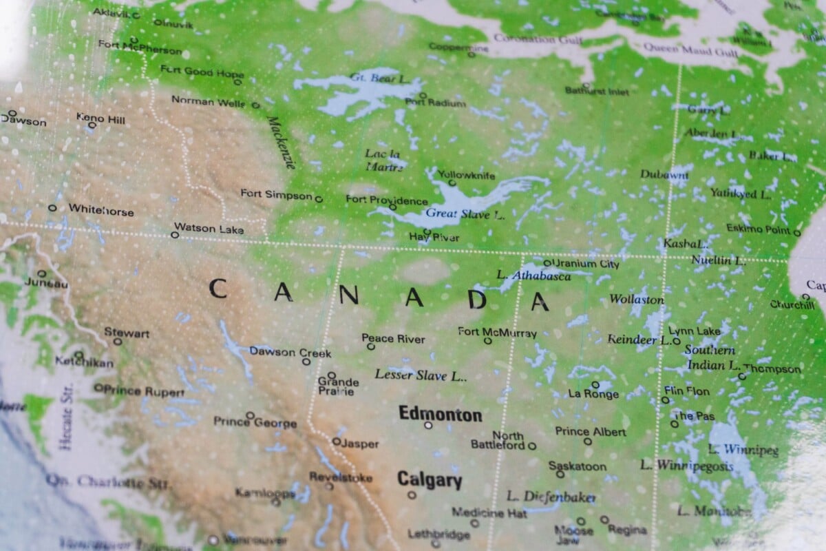 Close-up photo of a map showing regions of Canada, highlighting key cities and geographical landmarks.