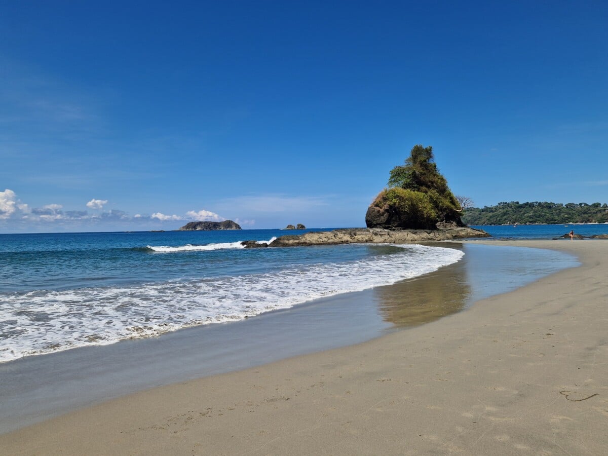 A sandy beach and rocky headland in Manuel Antonio National Park