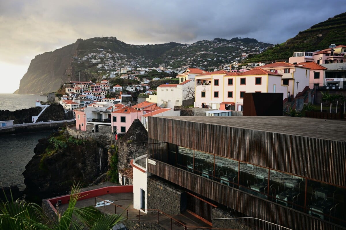 discover the charming coastal village in madeira with its stunning cliffs and co | Two Scots Abroad Discover the charming coastal village in Madeira with its stunning cliffs and colorful architecture during sunset.