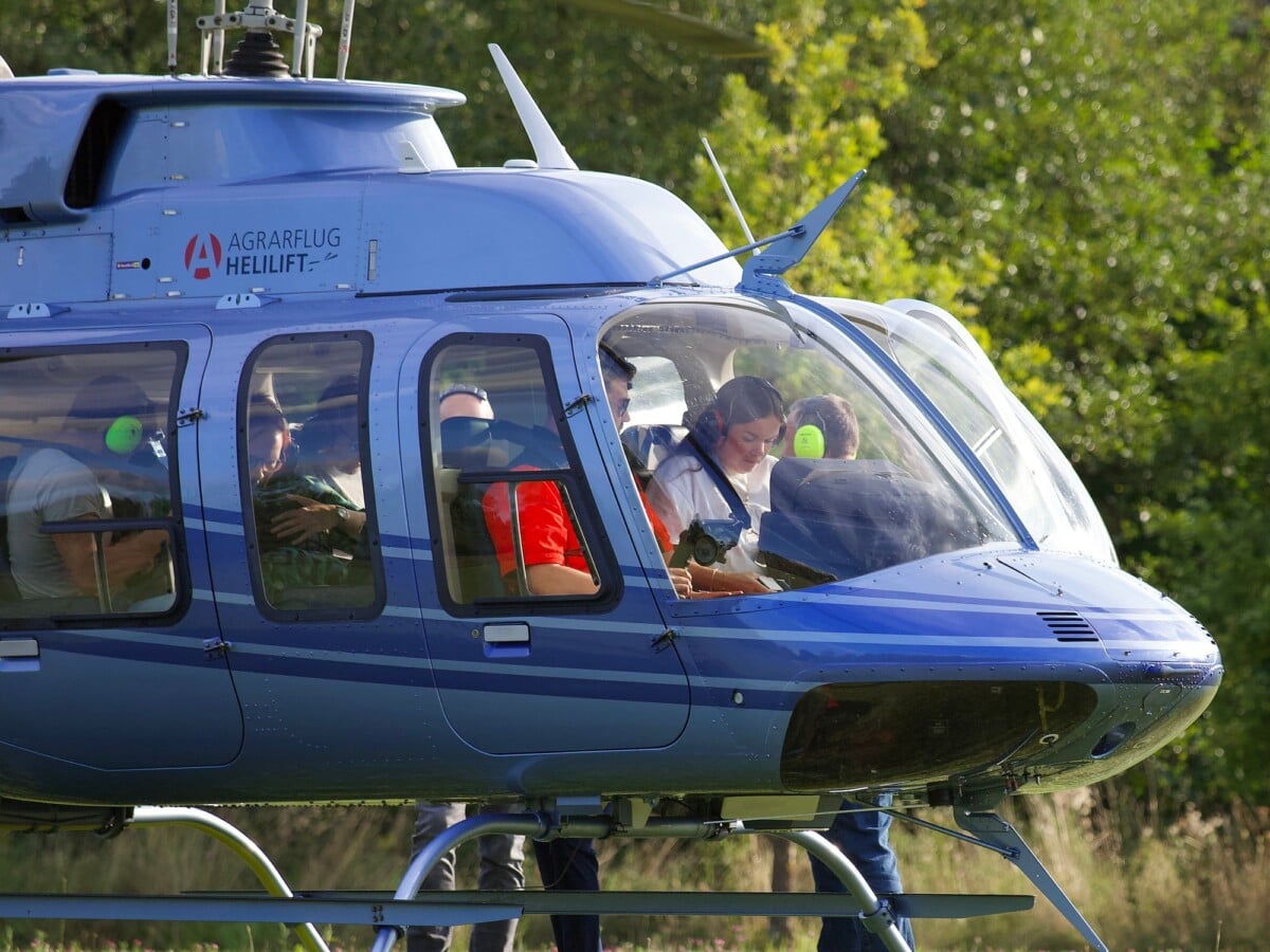 Passengers prepare for a scenic helicopter tour on a clear day.
