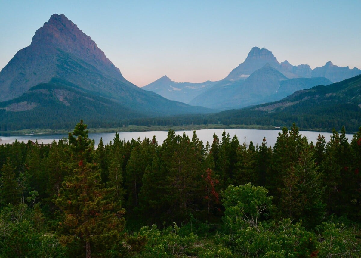 serene mountain landscape featuring grinnell point and lush forest in glacier na | Two Scots Abroad Grinnell Point above a lake and forest in Glacier National Park’s Many Glacier area