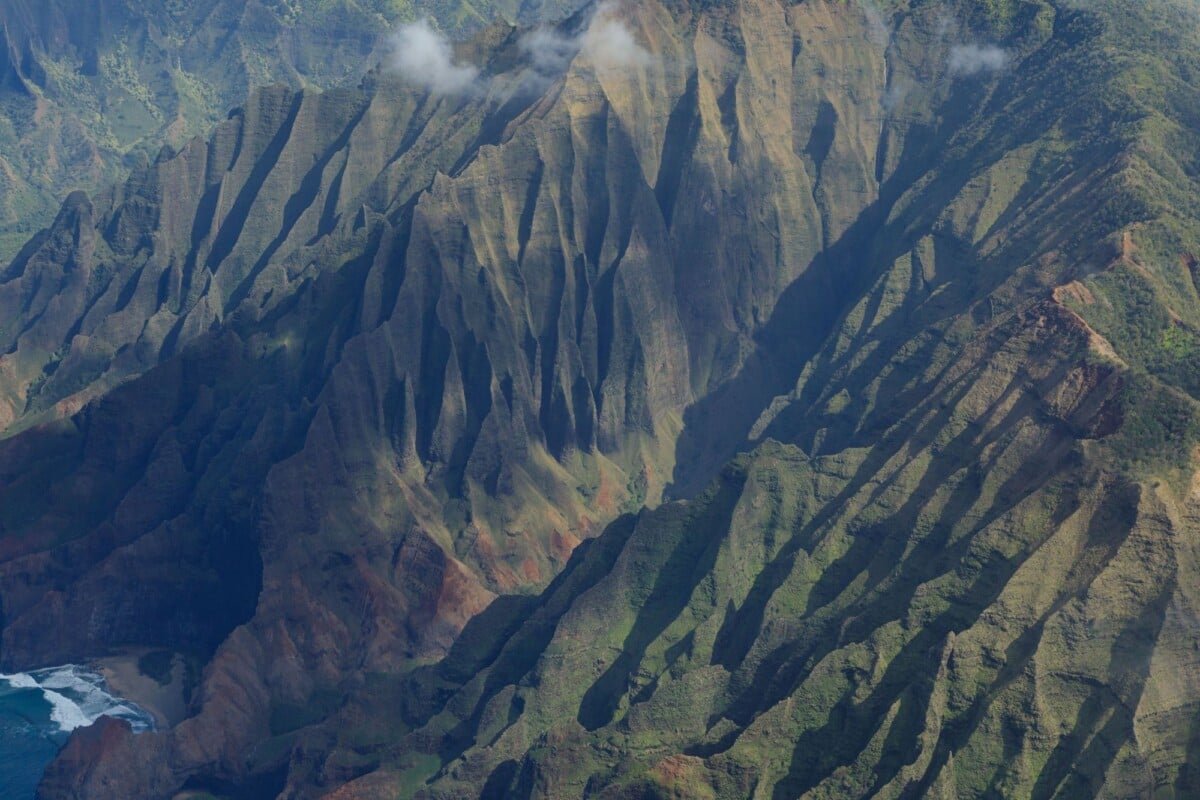 Stunning aerial shot of the rugged Na Pali coast in Kauai featuring dramatic cliffs.