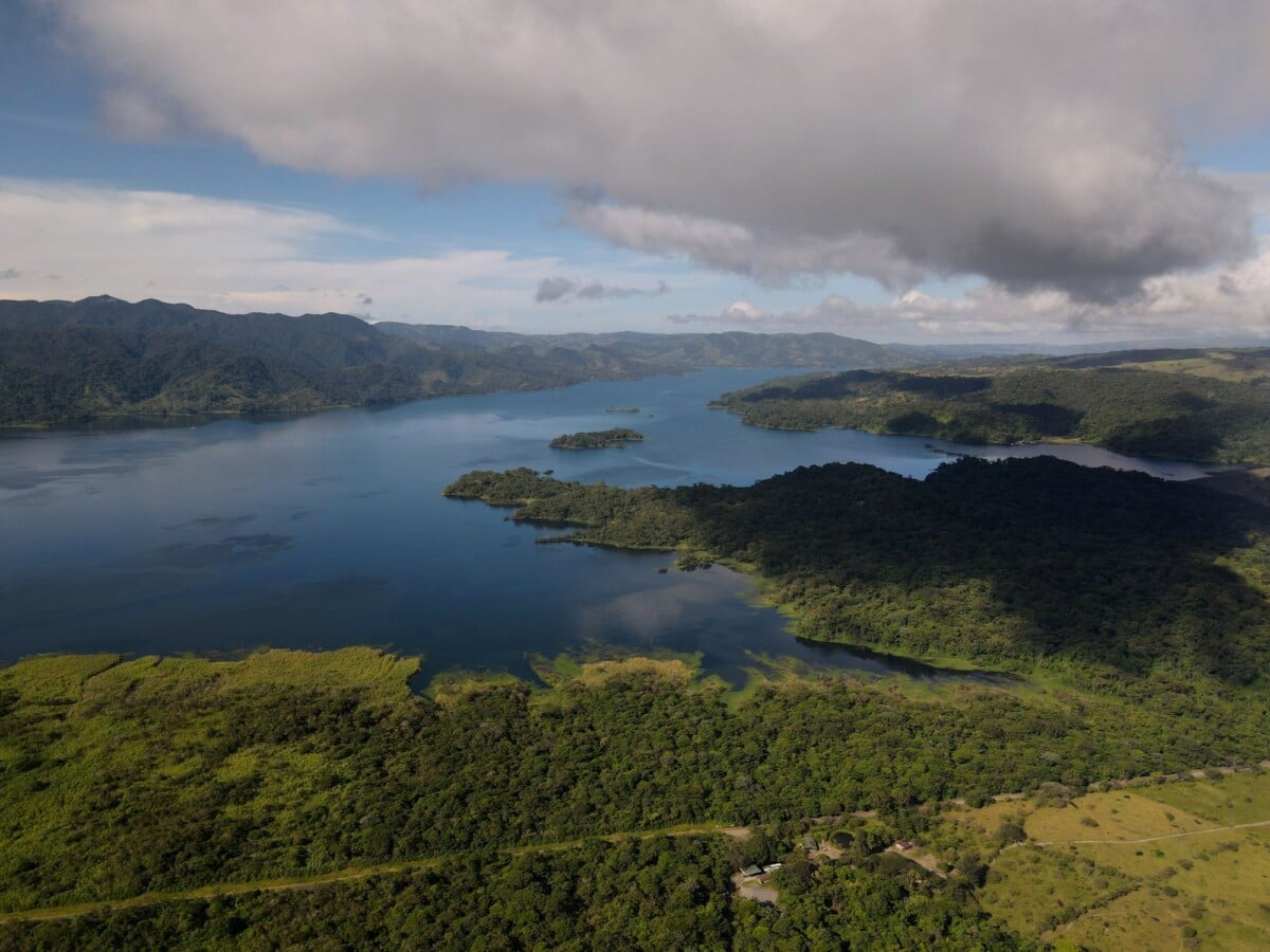 Lake Arenal surrounded by wooded hills beneath low cloud