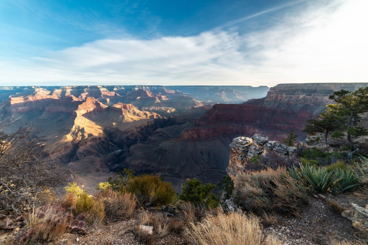 stunning landscape of the grand canyon with vivid rock formations under a bright | Two Scots Abroad Red rock layers of the Grand Canyon under a bright sky, one of the best national parks to visit in November
