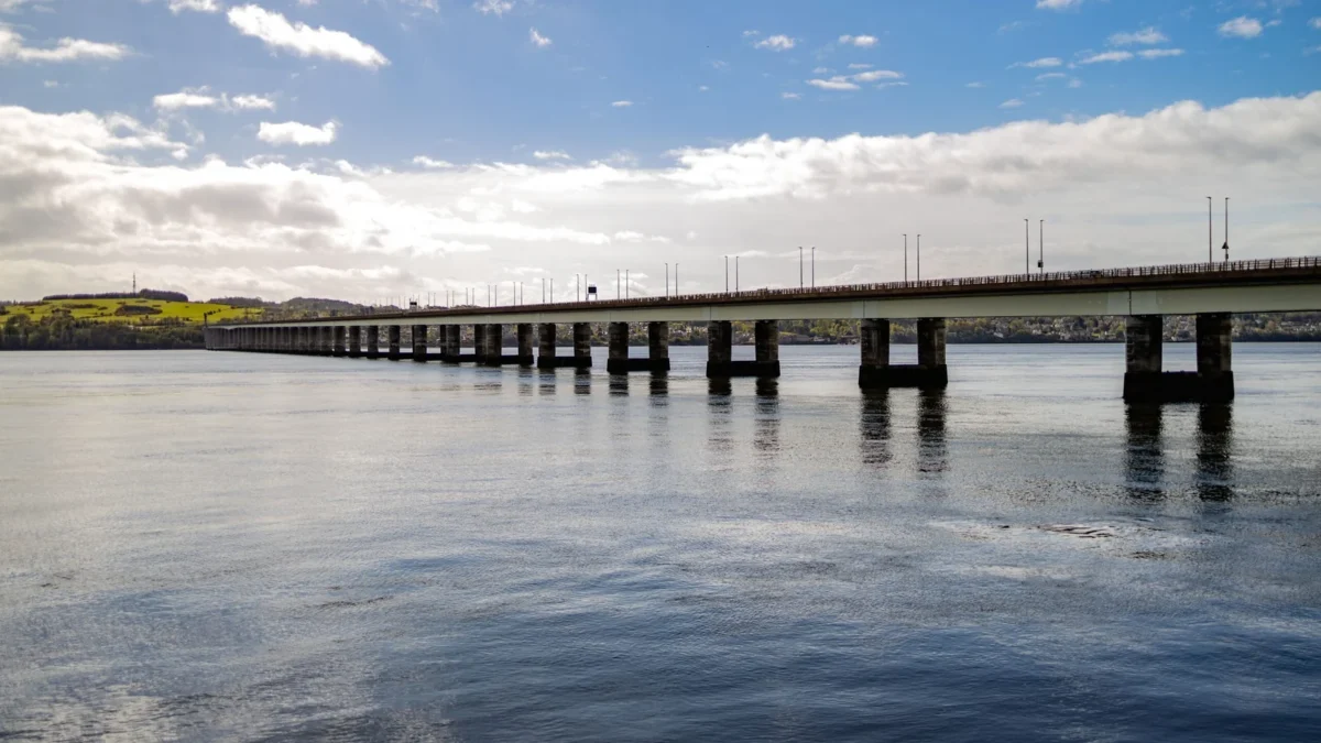 things to do in dundee featured | Two Scots Abroad The Tay Road Bridge crossing the calm River Tay from Dundee towards Fife under a blue sky, one of the free things to do in Dundee