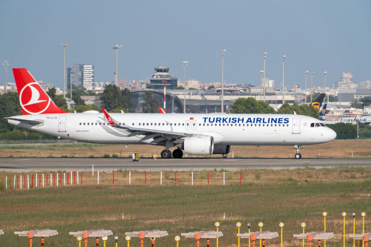 turkish airlines airbus a321neo on the runway at manises airport ready for takeo | Two Scots Abroad Turkish Airlines Airbus A321neo on the runway at Manises airport, ready for takeoff with a clear, sunny sky.